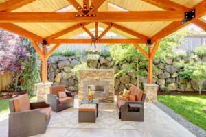 a paved patio with outdoor fireplace and custom cover